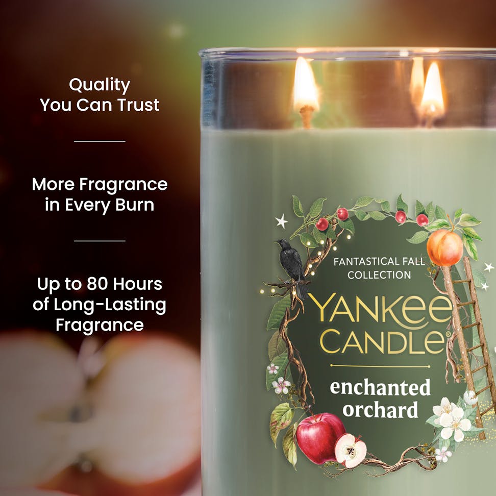 Large green scented candle with dual wicks, fruit and floral design, text highlights long-lasting fragrance benefits
