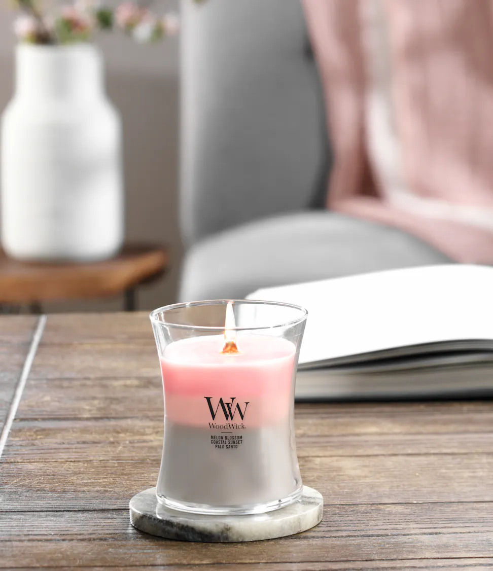 melon blossom and coastal sunset and palo santo trilogy medium jar candle on lid