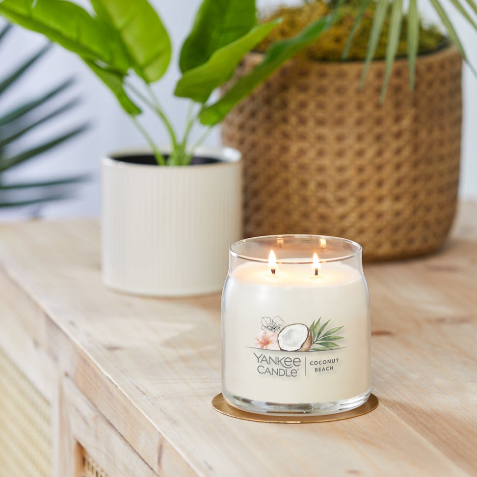 coconut beach signature medium jar candle on table