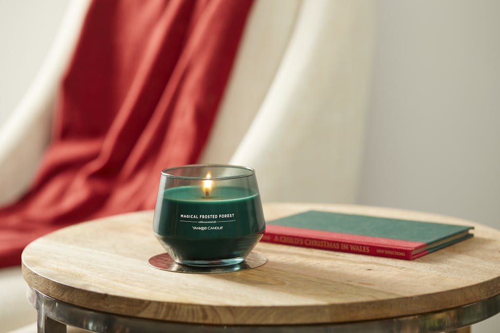 magical frosted forest studio collection jar candle on wooden accent table