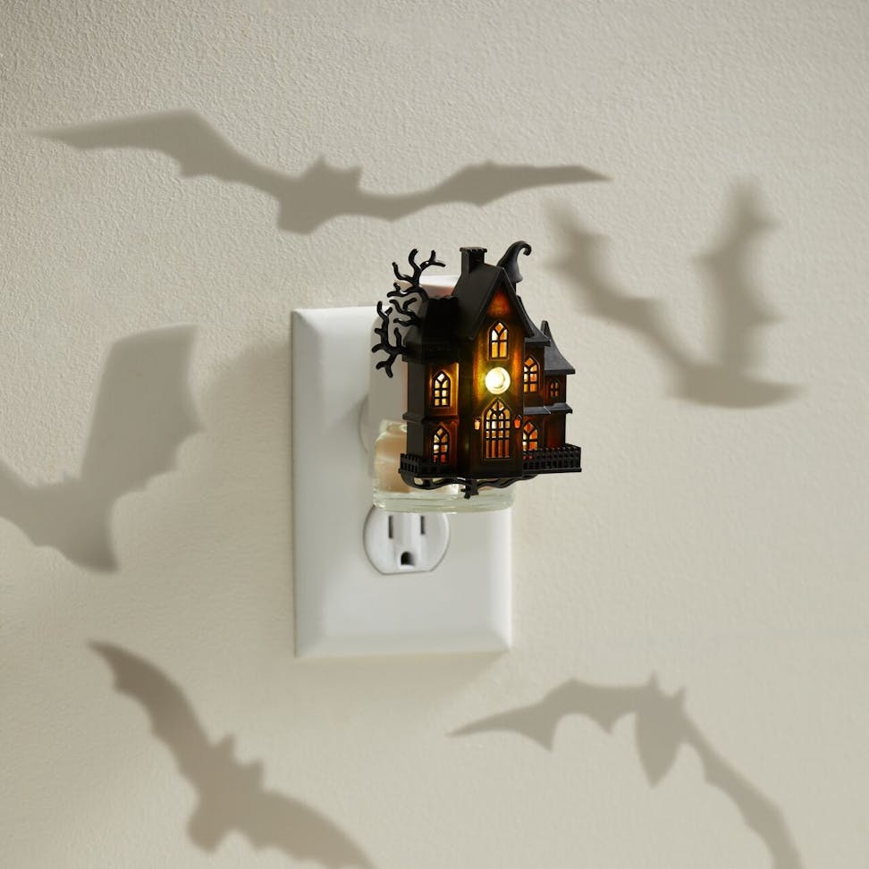 Halloween haunted house night light plug-in casting bat shadows on wall, spooky home decor accessory