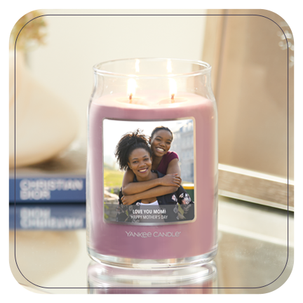 a pink-colored signature large jar candle with a personalized photo label of two women and a message reading l love you mom happy mother's day