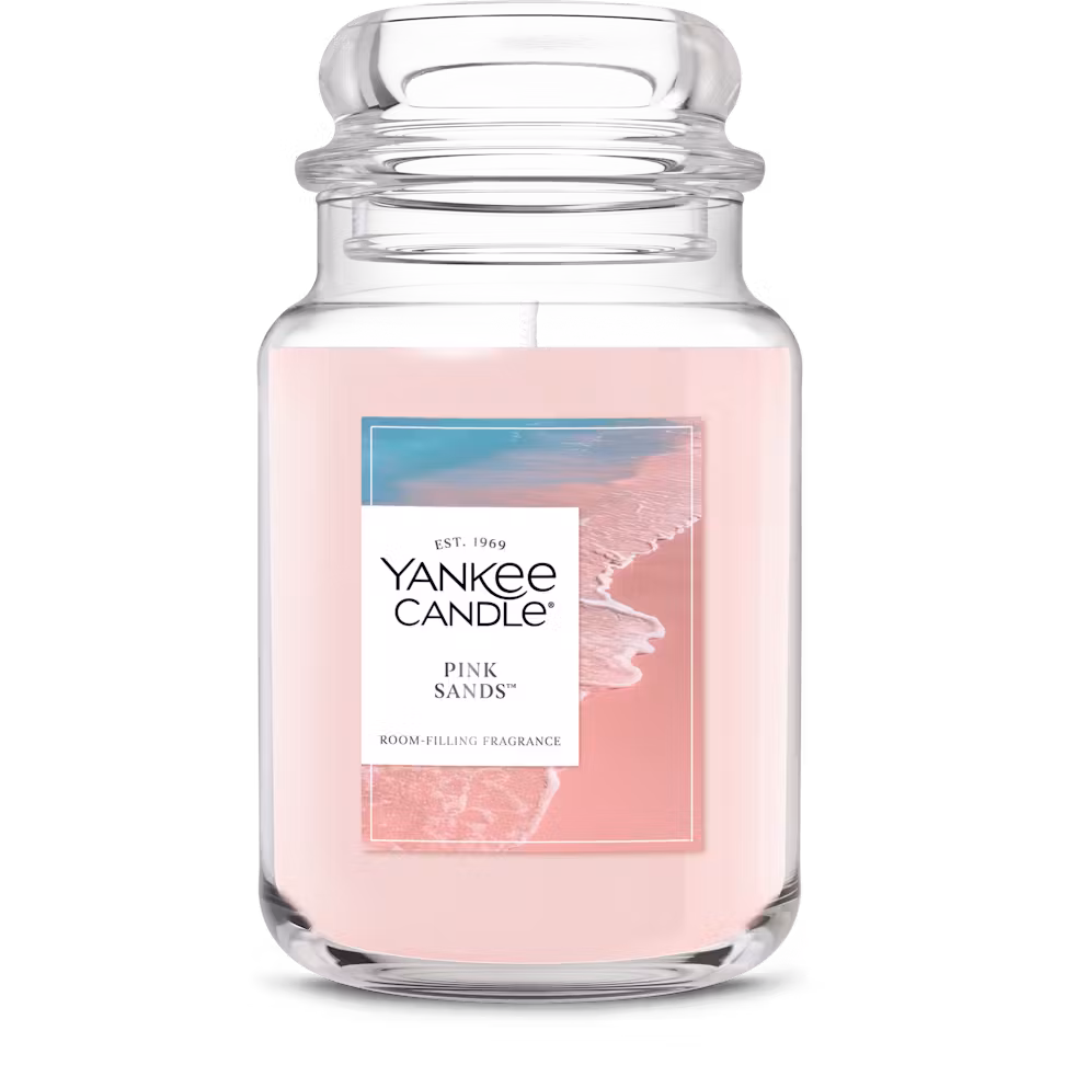 Pink Sands Yankee Candle in a jar against a pink background