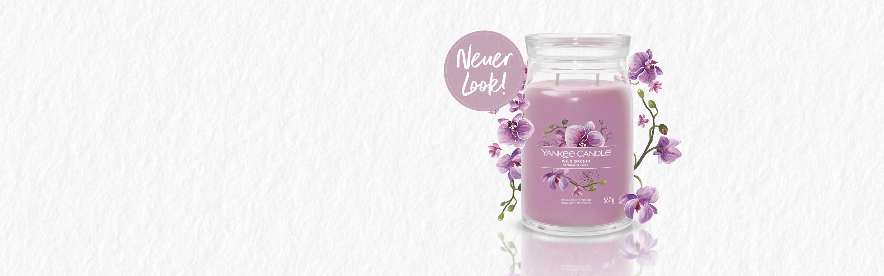 double wick mauve colored candle with orchid design