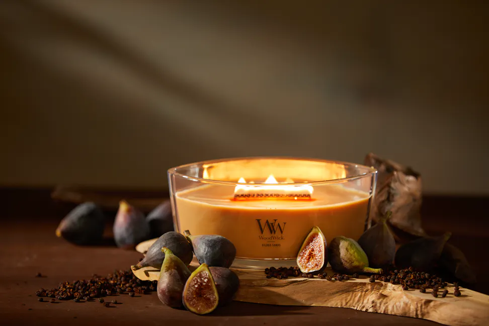 WoodWick Enchanted Destinations Collection Gilded Sands Ellipse Candle on a table