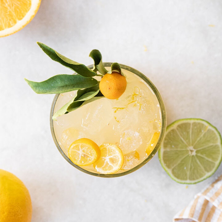 mixed drink with citrus garnish in kitchen setting