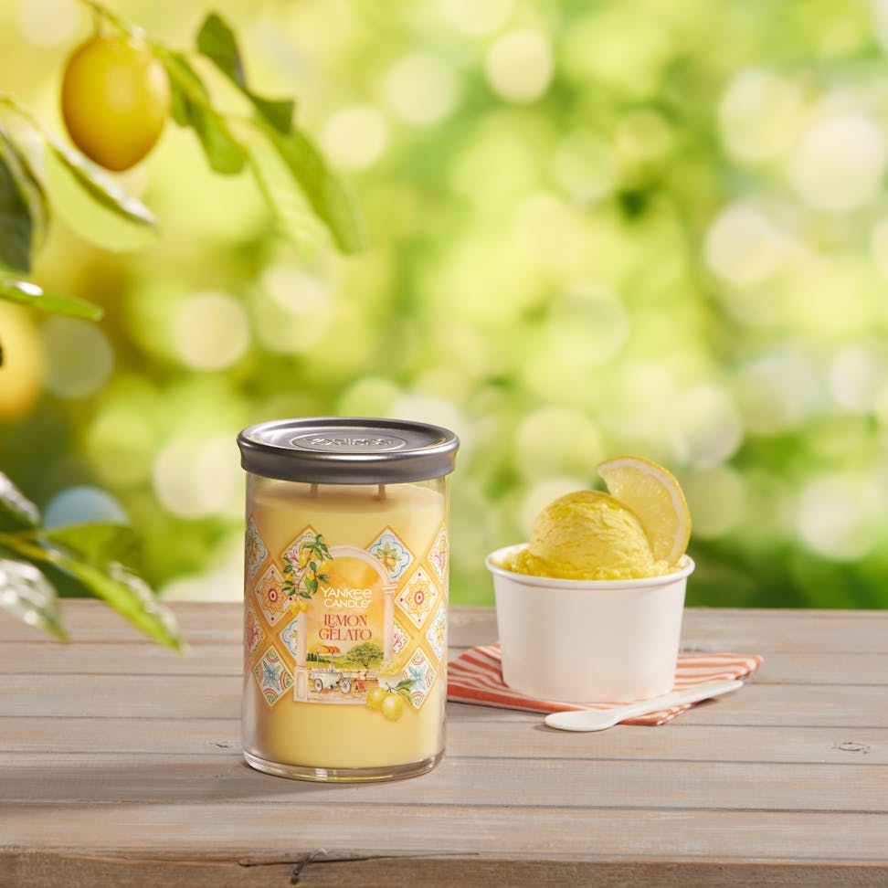 Hello, Italy! Collection Lemon Gelato Signature Large Tumbler Candle on a table with a bowl of ice cream and a spoon