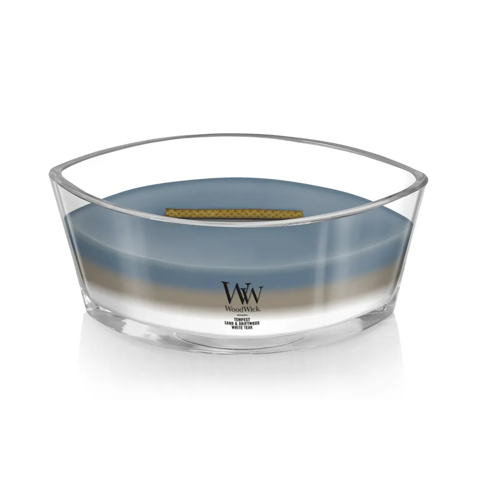 woodwick unchartered waters ellipse trilogy candle featuring layered scents of tempest, sand & driftwood, and white teak