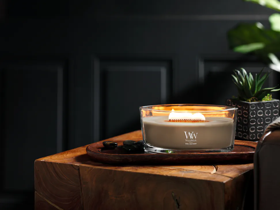 sand and driftwood ellipse candle on wooden tray