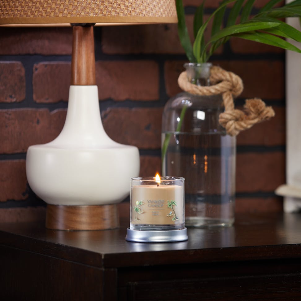 sun and sand signature small tumbler candle on table