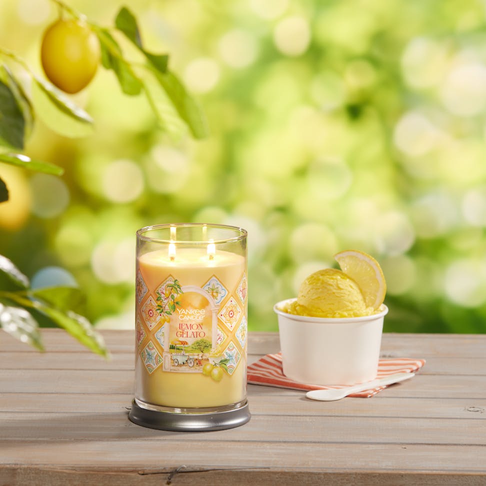 Hello, Italy! Collection Lemon Gelato Signature Large Tumbler Candle on a table with a cup of ice cream and a spoon
