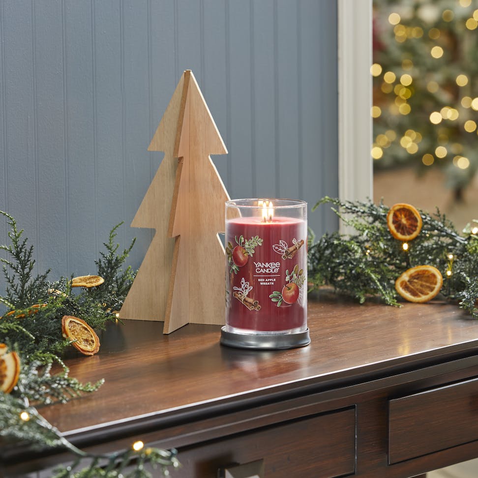 red apple wreath signature large tumbler candle on desk