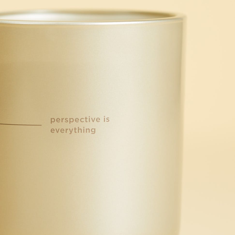 chesapeake bay candle intentions collection be positive citrus sugar medium two wick candle in a pastel yellow backdrop