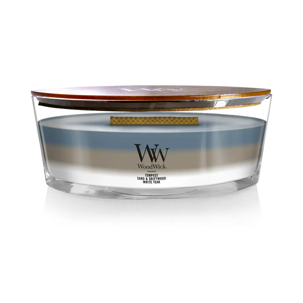 woodwick unchartered waters ellipse trilogy candle featuring layered scents of tempest, sand & driftwood, and white teak