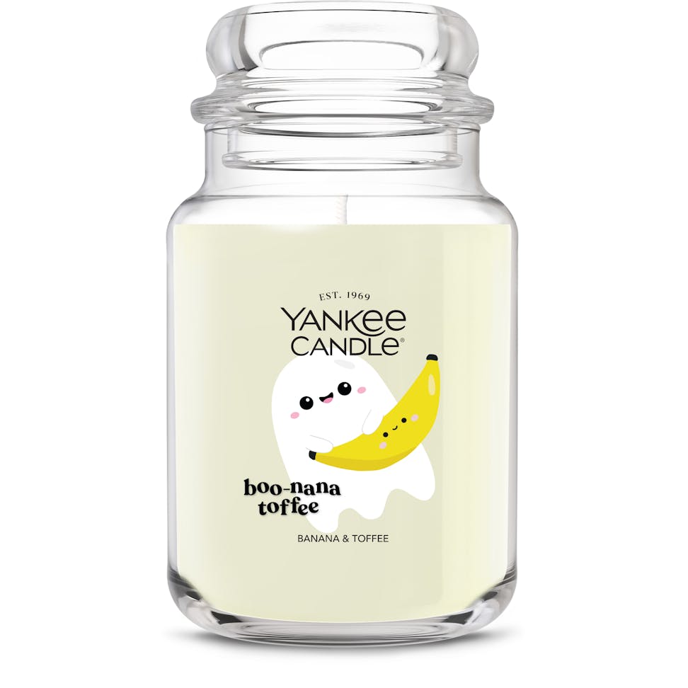 Large glass jar candle with banana and toffee scent, featuring cute ghost and banana illustration for home decor