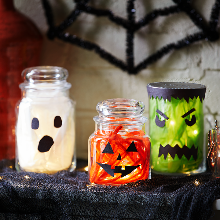 halloween decorations made out of candle jars