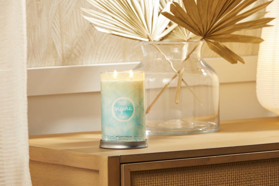 inspire scent of the year signature large tumbler candle on table