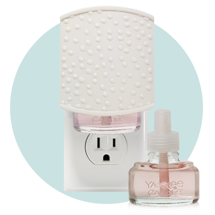 Sprinkle Dots ScentPlug Diffuser and two pink-colored ScentPlug Refills in a blue background