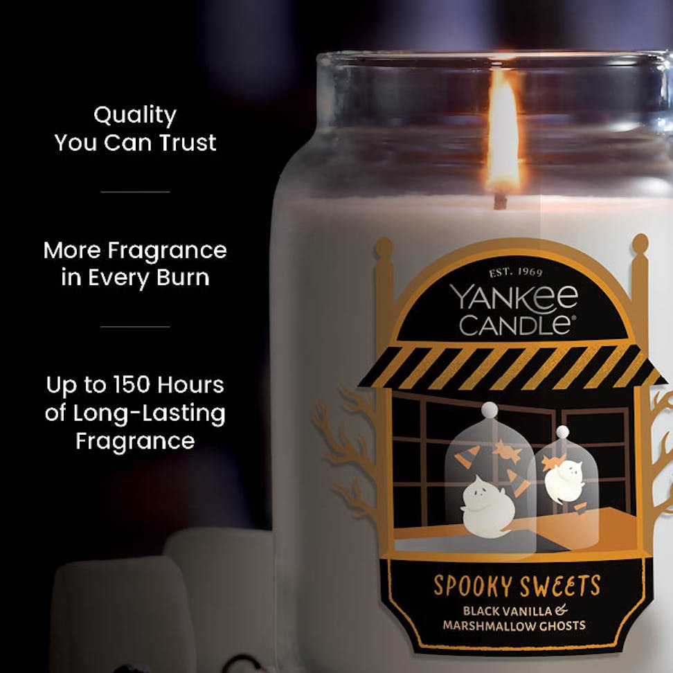 Large scented candle with spooky sweets design, burning for hours, features long-lasting fragrance and quality claims.
