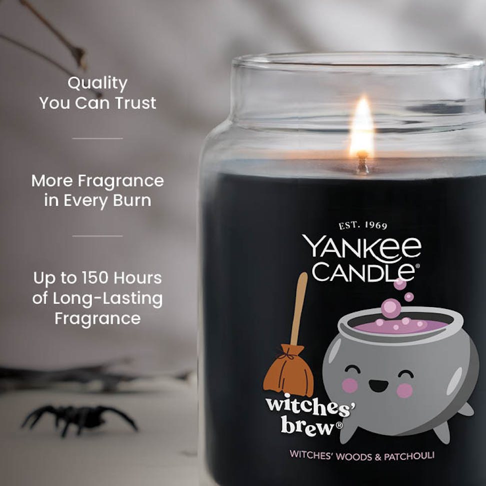 Large black scented candle in glass jar with text promoting quality, long-lasting fragrance, and more fragrance per burn