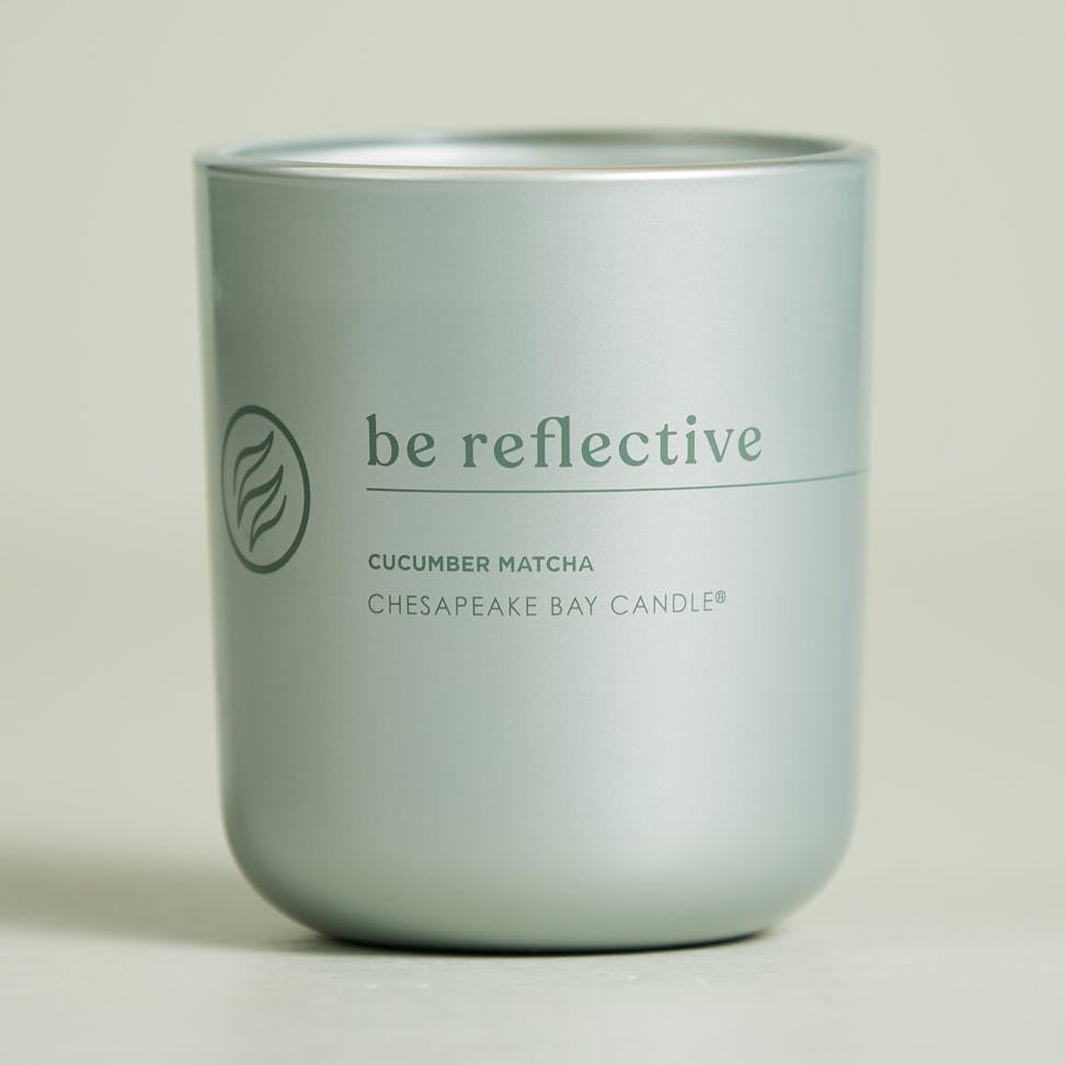 chesapeake bay candle intentions collection be reflective cucumber matcha medium two wick candle in a pastel teal backdrop