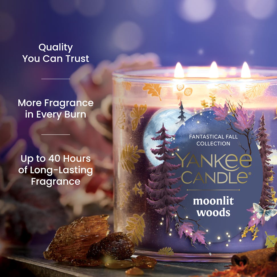 Large decorative candle with forest design, glowing flames, and text highlighting long-lasting fragrance benefits.