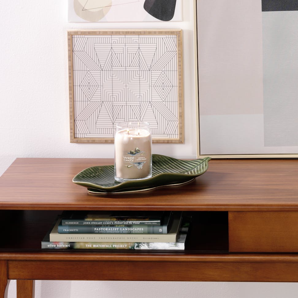 amber and sandalwood signature large jar candle on desk