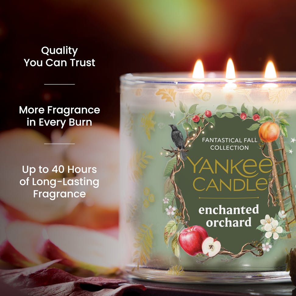 Three-wick scented candle with fruit and floral design, long-lasting fragrance, quality and burn time text visible.