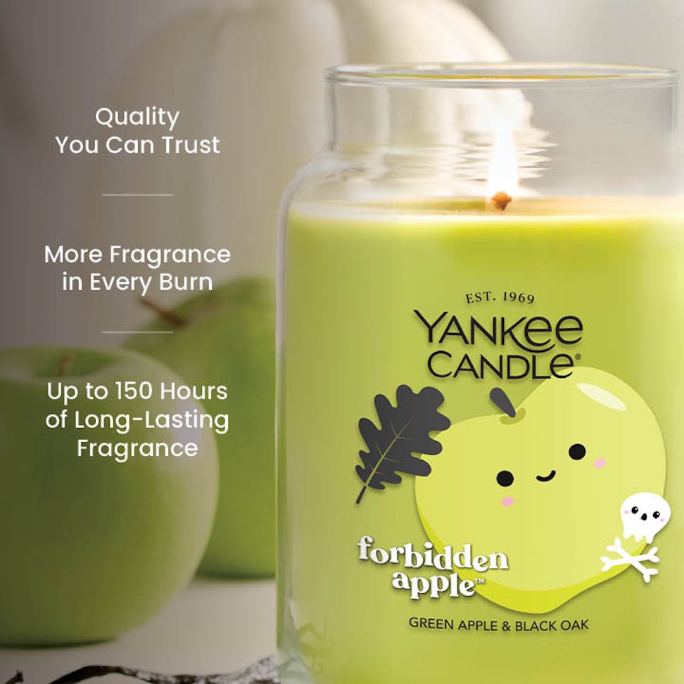 Large green apple scented candle in glass jar with long-lasting fragrance and quality text on side.