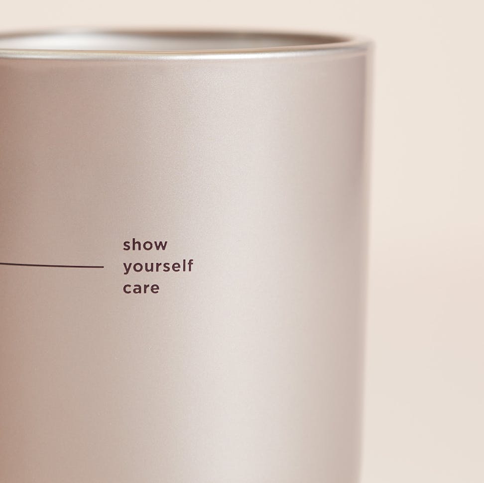 chesapeake bay candle intentions collection be thoughtful peony rose medium two wick candle in a pastel pink backdrop