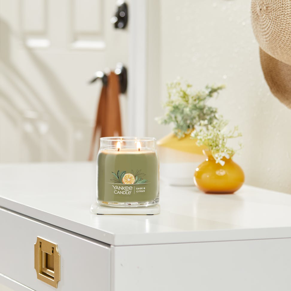 sage and citrus signature medium jar candle on table